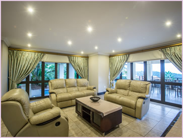 Downstairs lounge at 22 Acaciawood, with luxury leather recliner couches and HD TV with DSTV PVR